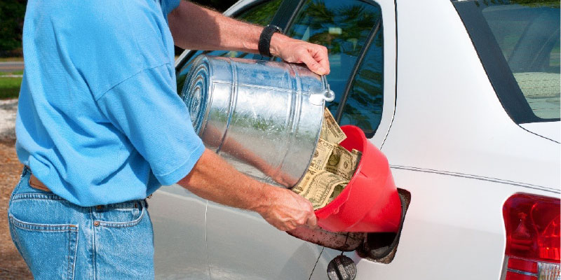 Man pouring money into his gas tank